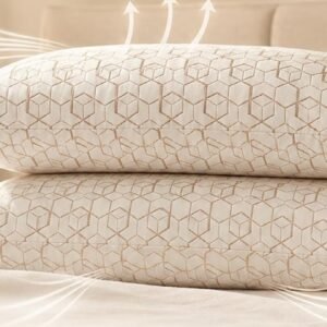 Snoozel copper infused pillows stacked on a bed