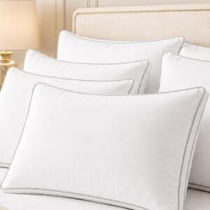 Snoozel luxury pillows with piped edges on a made bed